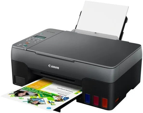 Tlačiareň Canon s papierom a farebnými náplňami.