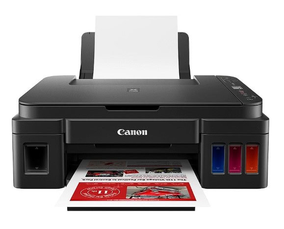 Canon tlačiareň s farebnou tlačou a papierom pripraveným na tlač.